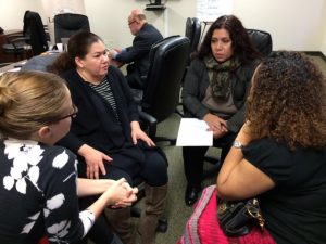 Layla Sulieman Gonzalez, Executive Director, Illinois Latino Family Commission, taking notes during her conversation with Katia Nuques and Docia Buffington of Enlace and Sol Flores of La Casa Norte after the presentation by Raza Development Fund. Foto: Mixed Voces