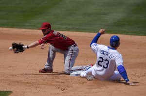 Los Angeles Dodgers' Adrian Gonzalez, right, takes second on a wild pitch as Arizona Diamondbacks second baseman Chris Owings takes a late throw from home during the fourth inning of a baseball game, Sunday, May 3, 2015, in Los Angeles. (AP Photo/Mark J. Terrill)