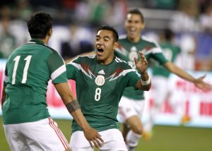 Mexico midfielder Marco Fabian (8) celebrates with Alan Pulido (11) after Pulido scored during the second half of an international friendly soccer match against the U.S. Wednesday, April 2, 2014, in Glendale, Ariz. The game ended in a 2-2 draw. (AP Photo/Rock Scuteri)