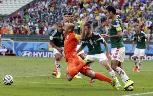 AP10ThingsToSee - Netherlands' Arjen Robben, center, goes down to win a penalty during the World Cup round of 16 soccer match between the Netherlands and Mexico at the Arena Castelao in Fortaleza, Brazil, Sunday, June 29, 2014. Netherlands won the match 2-1. (AP Photo/Wong Maye-E)