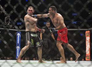 Brazil's Fabricio Werdum lands a punch to United States' Cain Velasquez during a heavyweight mixed martial arts title bout at UFC 188 in Mexico City, Saturday, June 13, 2015. Werdum won the fight by submission. (AP Photo/Christian Palma)