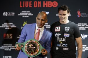 Boxers Miguel Cotto, left, with his WBC World middleweight title belt, and Daniel Geale pose for photographers during a news conference, Tuesday, June 2, 2015, in New York. Cotto is slated to defend his middleweight title against Geale on Saturday, June 6, at Barclays Center in the Brooklyn borough of New York.  (AP Photo/Mary Altaffer)