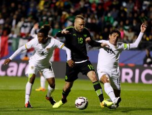 Mexico's Vicente Vuoso , center, fights for the control of the ball with Bolivia's Leonel Morales , left, and Ronald Raldes  during a Copa America Group A soccer match at the Sausalito Stadium in Vina del Mar, Chile, Friday, June 12, 2015. (AP Photo/Ricardo Mazalan)