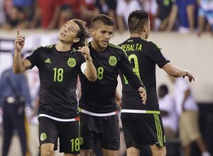 Mexico's Andres Guardado (18) and Jonathan Dos Santos (8) celebrate during the overtime period of a CONCACAF Gold Cup soccer match against Costa Rica Sunday, July 19, 2015, at MetLife stadium in East Rutherford, N.J. Mexico won 1-0. (AP Photo/Seth Wenig)