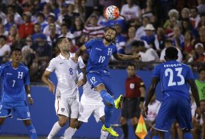 Honduras' Afredo Mejia (19) jumps for the header against U.S. forward Clint Dempsey (8) during the second half of a CONCACAF Gold Cup soccer match in Frisco, Texas, Tuesday, July 7, 2015. Looking on are Honduras' Carlos Discua (7) and Johnny Palacios. The U.S. won 2-1. (AP Photo/LM Otero)