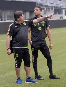 Mexico coach Miguel Herrera, left, and goalkeeper Guillermo Ochoa check out the pitch at MetLife Stadium for Sunday's Gold Cup soccer match against Costa Rica, Saturday, July 18, 2015, in East Rutherford, N.J. (AP Photo/Bill Kostroun)