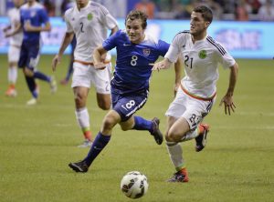 USA defender Jordan Morris (8) chases the ball against Mexico defender Hiram Mier during the first half of an international friendly soccer match, Wednesday, April 15, 2015, in San Antonio. (AP Photo/Darren Abate)