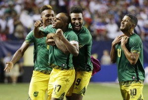 Jamaica’s Michael Seaton, Rudolph Austin, Giles Barnes and Joel McAnuff, from left, celebrate after Jamaica defeated the United States 2-1 in a CONCACAF Gold Cup soccer semifinal Wednesday, July 22, 2015, in Atlanta. (AP Photo/David Goldman)