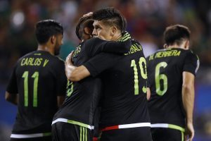 Mexico forward Oribe Peralta, right, celebrates scoring a goal against Cuba with midfielder Jonathan Dos Santos, left, during the first half of a CONCACAF Gold Cup soccer match, Thursday, July 9, 2015, in Chicago. Mexico won 6-0. (AP Photo/Andrew A. Nelles)