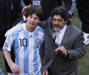 Argentina head coach Diego Maradona, right, and Argentina's Lionel Messi, left, walk off the pitch after winning the World Cup group B soccer match between Argentina and South Korea at Soccer City in Johannesburg, South Africa, Thursday, June 17, 2010. Argentina won 4-1.  (AP Photo/Marcio Jose Sanchez)