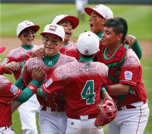 Mexico's Gerardo Lujano, second from left, celebrates with teammates after getting the final out of an International elimination baseball game against Venezuela at the Little League World Series tournament in South Williamsport, Pa., Thursday, Aug. 27, 2015. Mexico won 11-0. (AP Photo/Gene J. Puskar)