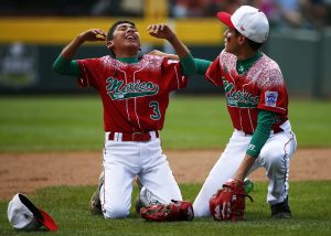 Mexico's Gerardo Lujano, right, comforts teammate Andres Villa (3) after a 1-0 loss to Japan in the International championship baseball game at the Little League World Series tournament in South Williamsport, Pa., Saturday, Aug. 29, 2015. (AP Photo/Gene J. Puskar)