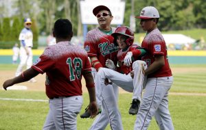Mexico's Jorge Armenta, second from right, is carried off the field by Isaac Sanchez, right, and Armando Verdugo, second from left, after Armenta's home run during the third inning of an International elimination baseball game against Australia at the Little League World Series, Monday, Aug. 24, 2015, in South Williamsport, Pa. Mexico won 14-3 in four innings. (AP Photo/Matt Slocum)