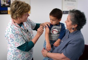 2006 Content Provided by: Judy Schmidt Grandmother holding a 3-year old boy while he receives intramuscular immunization in upper arm. Vaccinations are most often given via the intramuscular route in the deltoid or thigh muscle, to optimize the immune response of the vaccine and reduce the adverse reactions in and around the injection site.