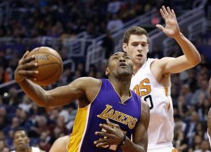 Los Angeles Lakers' Metta World Peace, left, gets fouled as he goes up for a shot as Phoenix Suns' Jon Leuer, right, defends during the first half of an NBA basketball game Monday, Nov. 16, 2015, in Phoenix. (AP Photo/Ross D. Franklin)