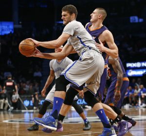 Brooklyn Nets center Brook Lopez (11) backs into the paint with Phoenix Suns center Alex Len (21) defending in the second half of an NBA basketball game at the Barclays Center, Tuesday, Dec. 1, 2015, in New York. The Nets won 94-91. (AP Photo/Kathy Willens)
