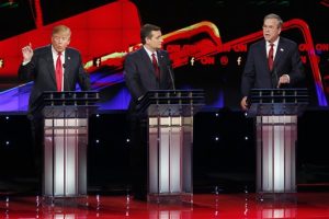 Donald Trump, a la izquierda, y Jeb Bush, a la derecha, hablan ante la mirada de Ted Cruz durante el debate republicano de CNN en el hotel y casino Venetian de Las Vegas. Foto: AP