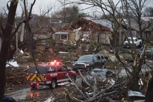 Un vehículo de emergencia avanza por un barrio en Rowlett, Texas, luego del paso de un tornado. Foto: AP