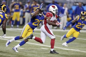 Arizona Cardinals running back Kerwynn Williams, right, runs with the ball as St. Louis Rams cornerback Lamarcus Joyner defends during the third quarter of an NFL football game on Sunday, Dec. 6, 2015, in St. Louis. (AP Photo/Tom Gannam)