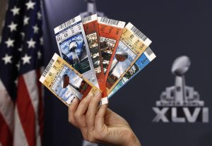 Samples of counterfeit tickets seized from previous NFL Super Bowls are held up by NFL Vice President for Legal Affairs Anastasia Danias during a news conference on counterfeit merchandise in Indianapolis February 2, 2012. The New York Giants will play the New England Patriots in the Super Bowl XLVI on February 5. REUTERS/Jim Young  (UNITED STATES - Tags: SPORT FOOTBALL) - RTR2X7MQ