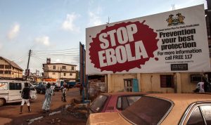 Gente pasa frente a un letrero que dice “STOP EBOLA” (Paren al ébola) que es parte de la campaña para liberar a Sierra Leona del ébola en la ciudad de Freetown. Foto: AP