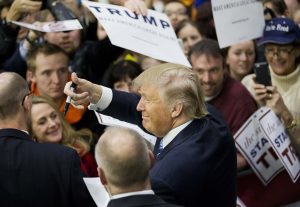 El aspirante a la candidatura republicana a la presidencia, Donald Trump, hace gestos al público mientras firma autógrafos en un acto de campaña en la Universidad del Estado de Plymouth, el domingo 7 de febrero de 2016 en Plymouth, New Hampshire. (AP Foto/David Goldman)