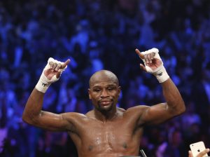 Floyd Mayweather Jr., celebrates his unanimous decision victory over Manny Pacquiao, from the Philippines, at the finish of their welterweight title fight on Saturday, May 2, 2015 in Las Vegas. (AP Photo/John Locher)
