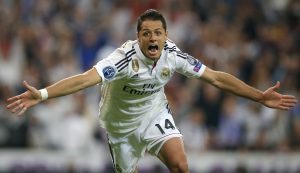 FILE - In this Wednesday April 22, 2015 file photo Real Madrid's Chicharito celebrates scoring his side's first goal during the second leg quarterfinal Champions League soccer match between Real Madrid and Atletico Madrid at Santiago Bernabeu stadium in Madrid, Spain. Real won the match 1-0 to go through to the semifinals. (AP Photo/Paul White, File)