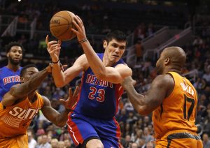 Detroit Pistons forward Ersan Ilyasova (23) drives between Phoenix Suns guard Eric Bledsoe, left, and P.J. Tucker (17) in the first quarter during an NBA basketball game, Friday, Nov. 6, 2015, in Phoenix. (AP Photo/Rick Scuteri)