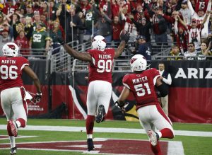 Arizona Cardinals defensive end Cory Redding (90) runs in a fumble recovery for a touchdown against the Green Bay Packers during the second half of an NFL football game, Sunday, Dec. 27, 2015, in Glendale, Ariz. (AP Photo/Ross D. Franklin)