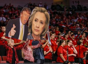 Nebraska fans try to distract Delaware State players with signs of Donald Trump and Hillary Clinton during the second half of an NCAA college basketball game in Lincoln, Neb., Thursday, Nov. 19, 2015. Nebraska won 75-60. (AP Photo/Nati Harnik)